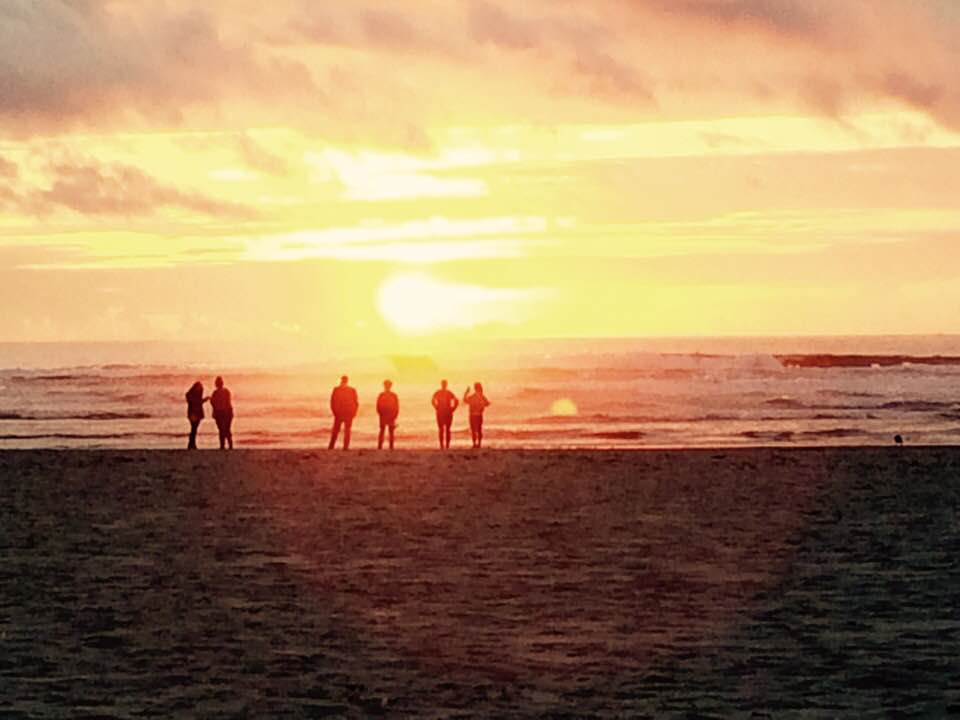 uLab members on beach with sunset